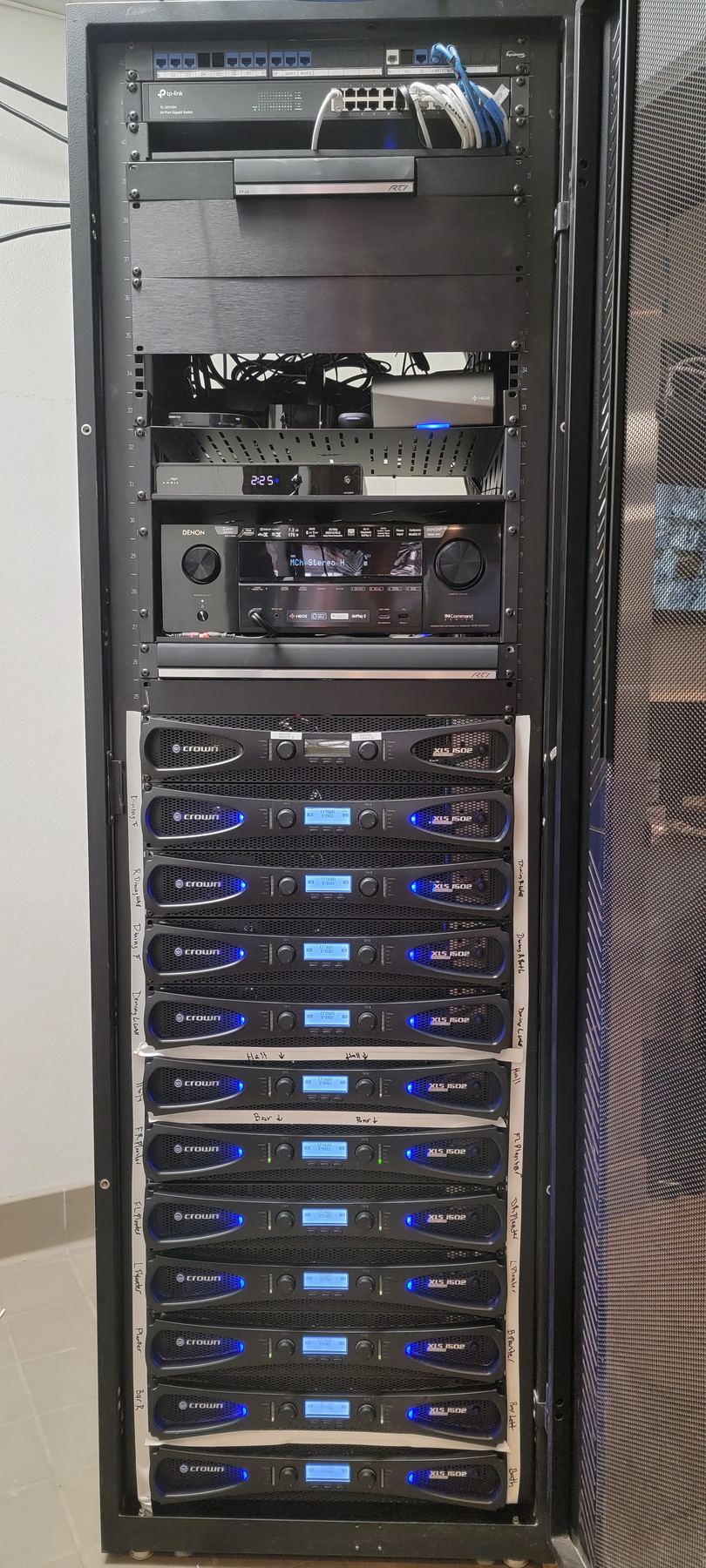 Tall equipment rack filled with multi-zone amplifiers
