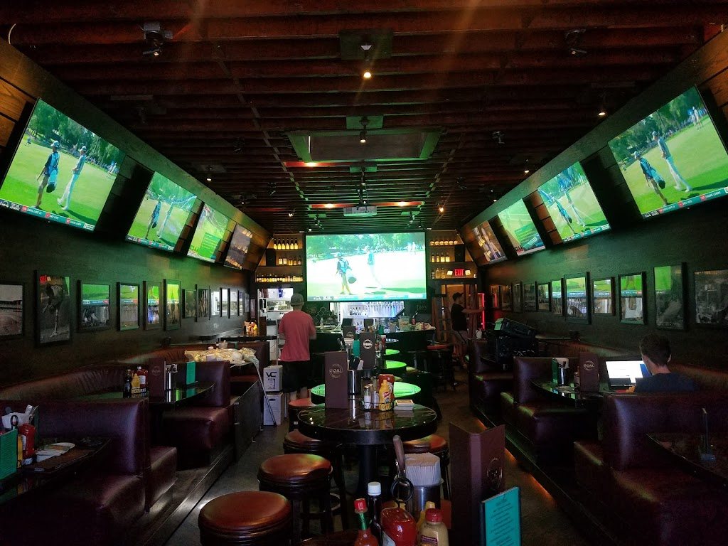 Sports bar with a projection screen over the bar and walls of TVs, audio and video installed by Dave's Home Theater